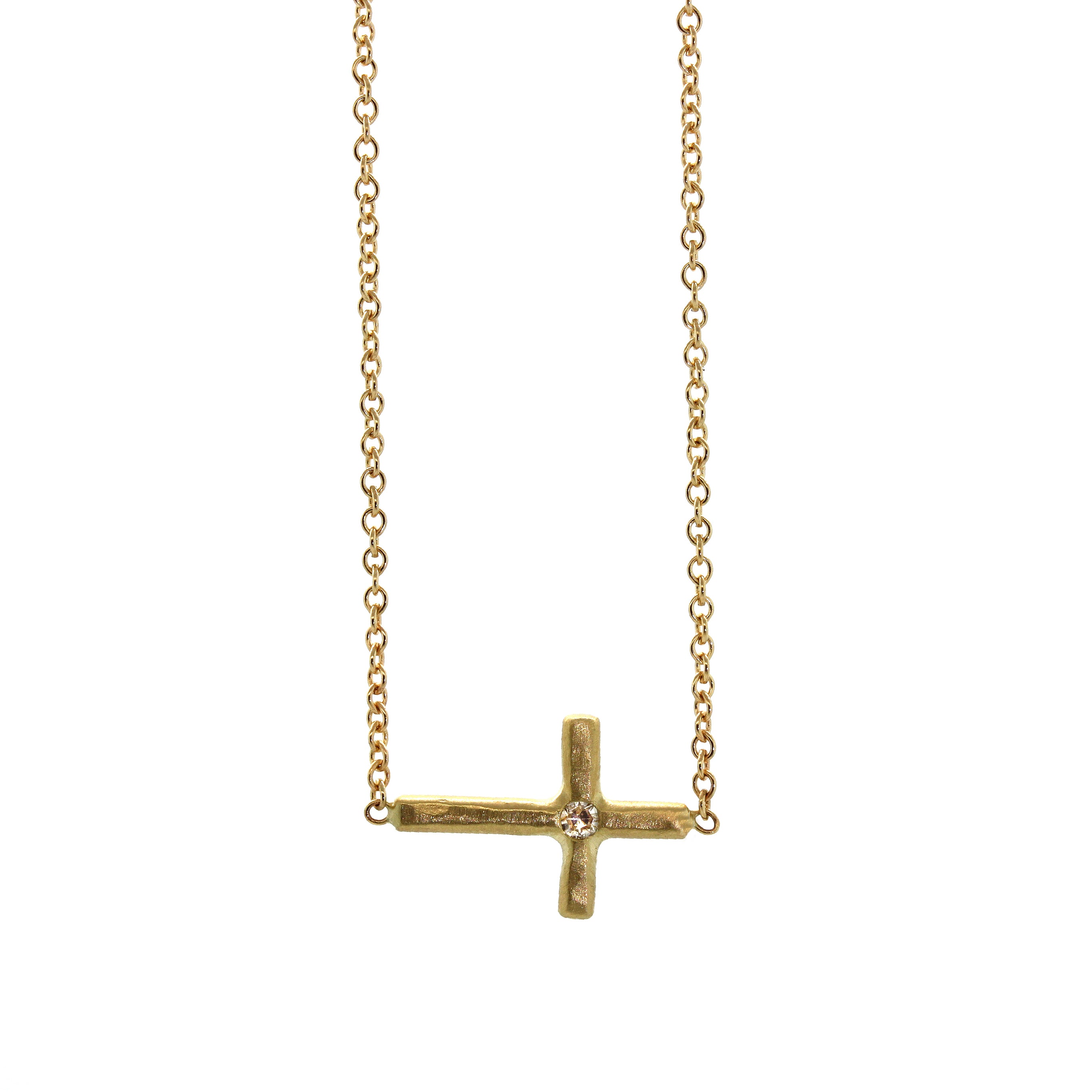 A simple RLD classic, this Sideways Cross & Diamond Necklace features a yellow gold cross with a single inlaid diamond set in the center and soldered sideways into the chain. It was handcrafted at Studio 703 by Rebecca Lankford in Houston, Texas.
