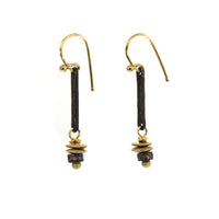 These Bohemian Dangle Earrings are handcrafted at Studio 703 + RLD by Rebecca Lankford. They feature an oxidized sterling silver bar with 2 yellow gold discs and a diamond roundel bead dangling from it. 