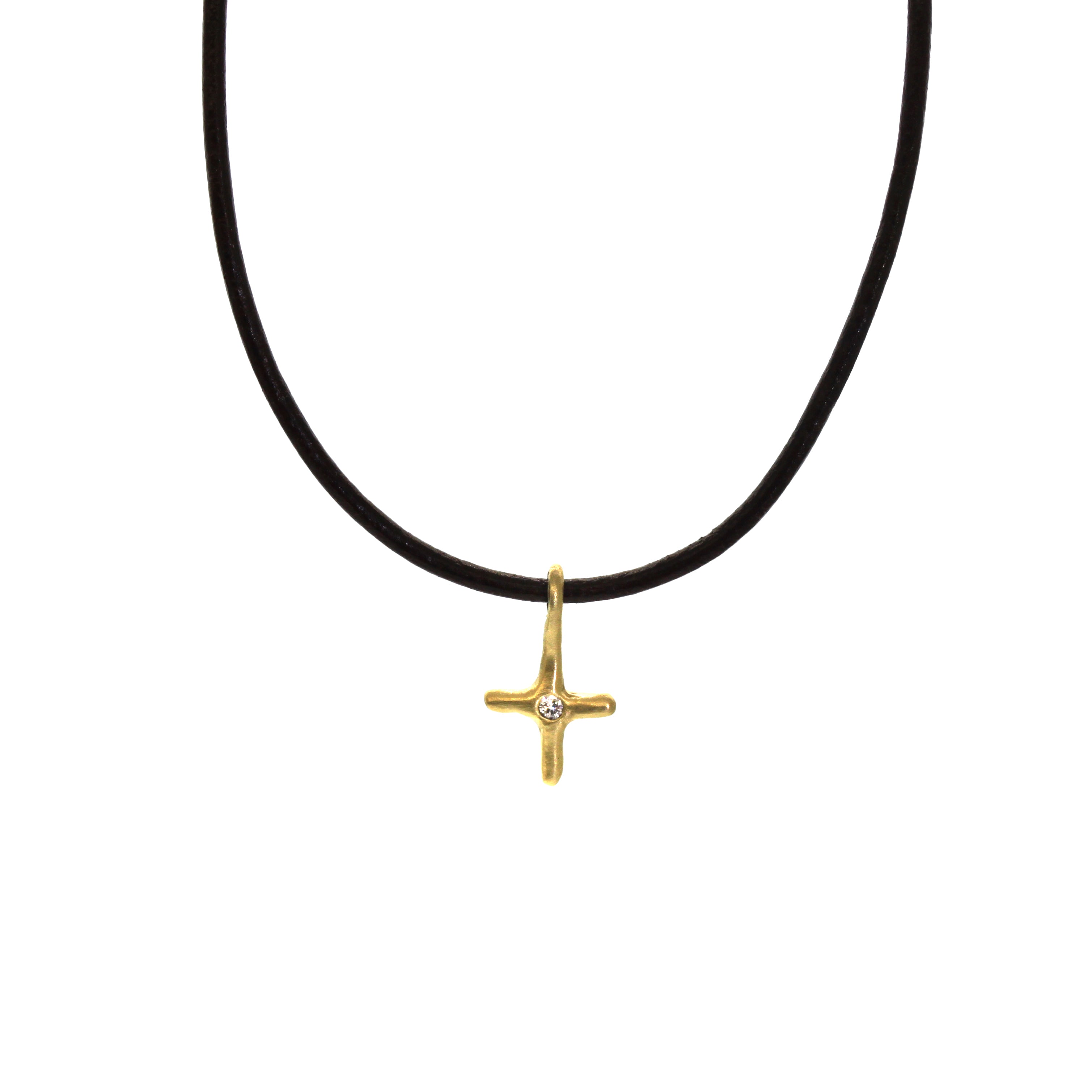 A simple everyday accessory or the perfect layering necklace, this Gold & Diamond Cross Necklace is a must-have. It features a small, organic yellow gold cross with a diamond inlaid in the center and dangling from brown leather. Each piece is handcrafted and made to order at Rebecca Lankford Designs in Houston, Texas.