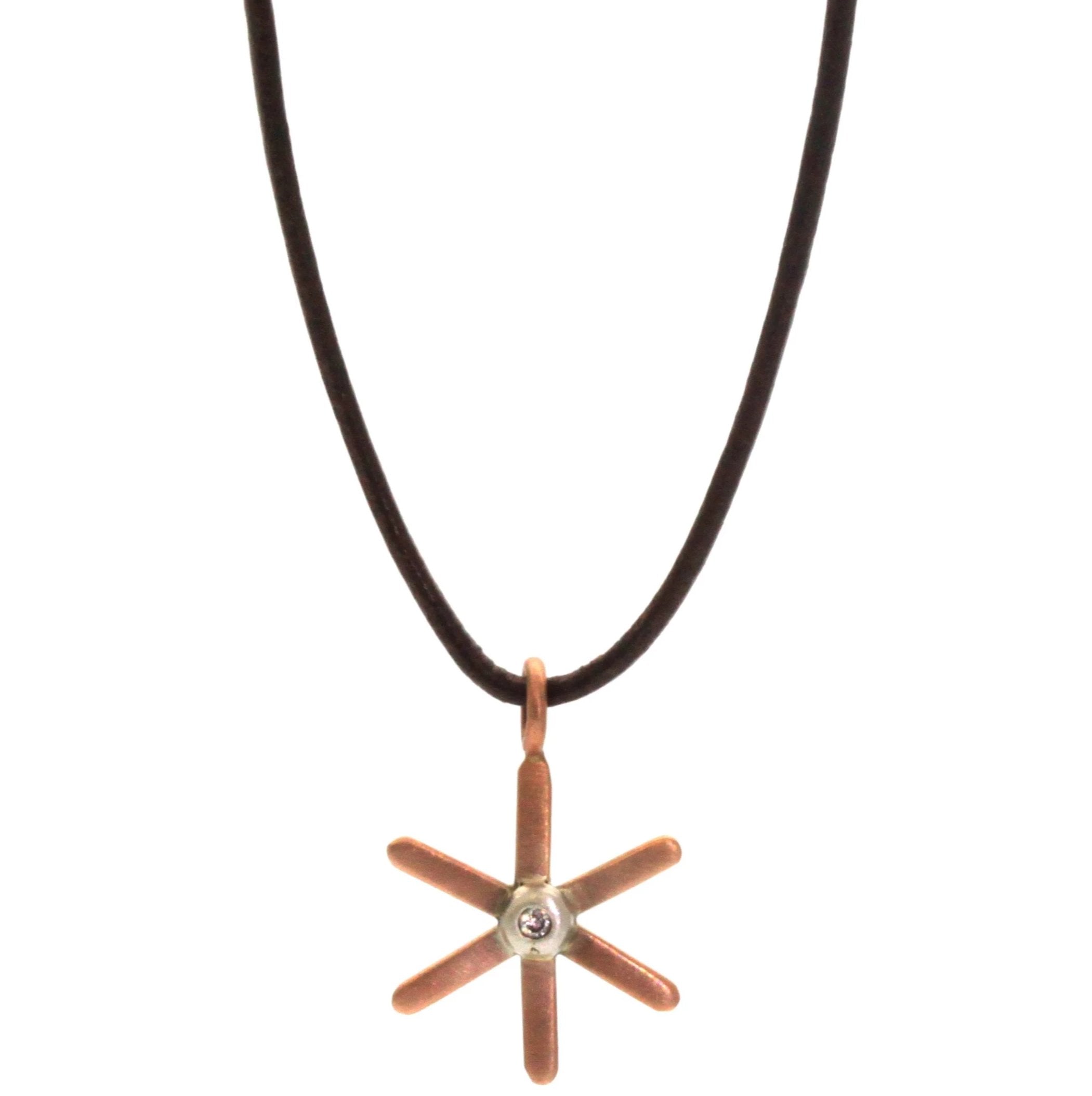 This Gold Starburst Necklace from Rebecca Lankford is a sweet pop of gold for everyone from children to adults! It features a gold, either rose or yellow, starburst pendant with a small diamond bezel set in white gold in the center. 