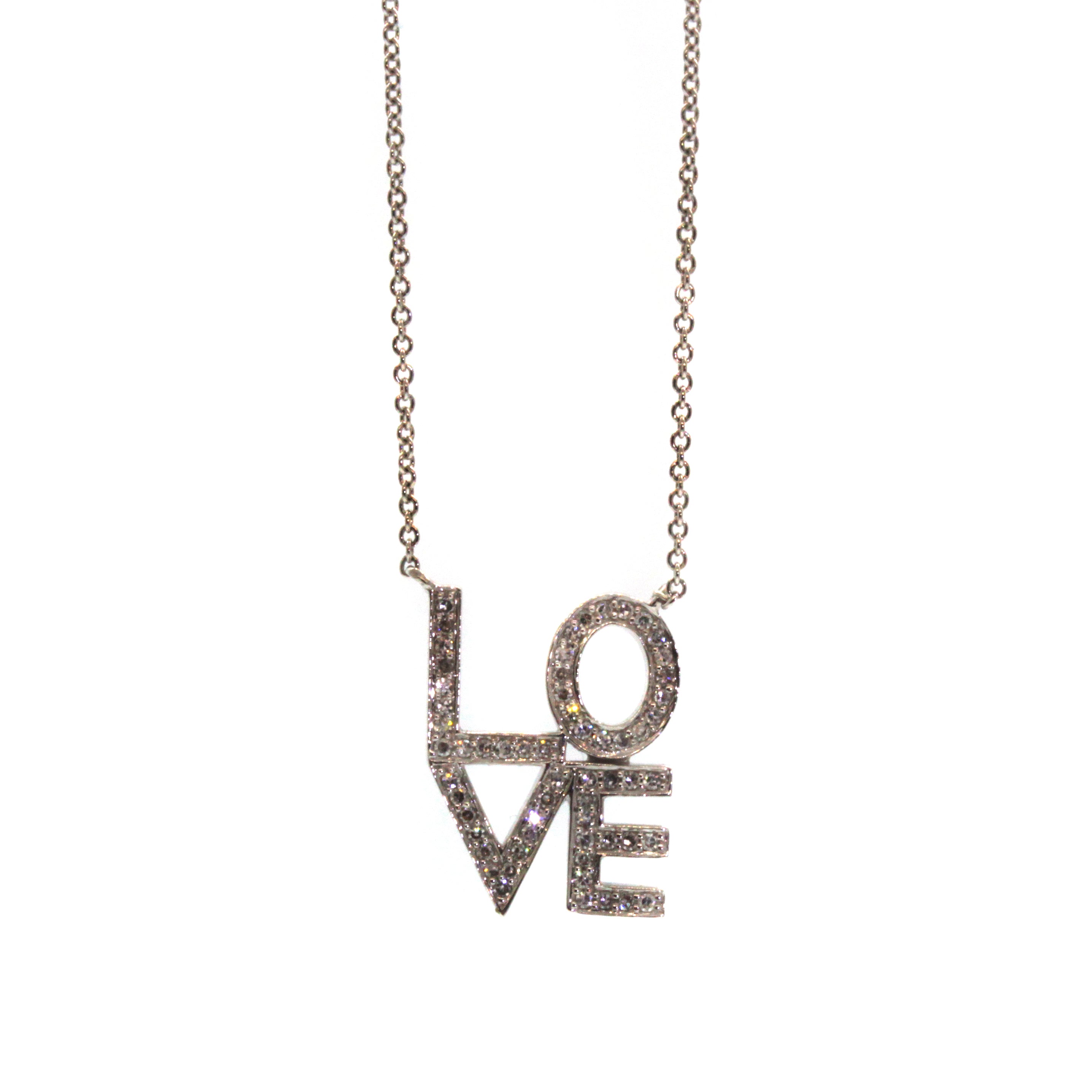 This Diamond Love Letter Necklace was handcrafted at Studio 703 + RLD in Houston, Texas. It features the letters "L" and "O" stacked on top of a "V" and "E" in 14k white gold and pave set with shimmering diamonds over each letter. 