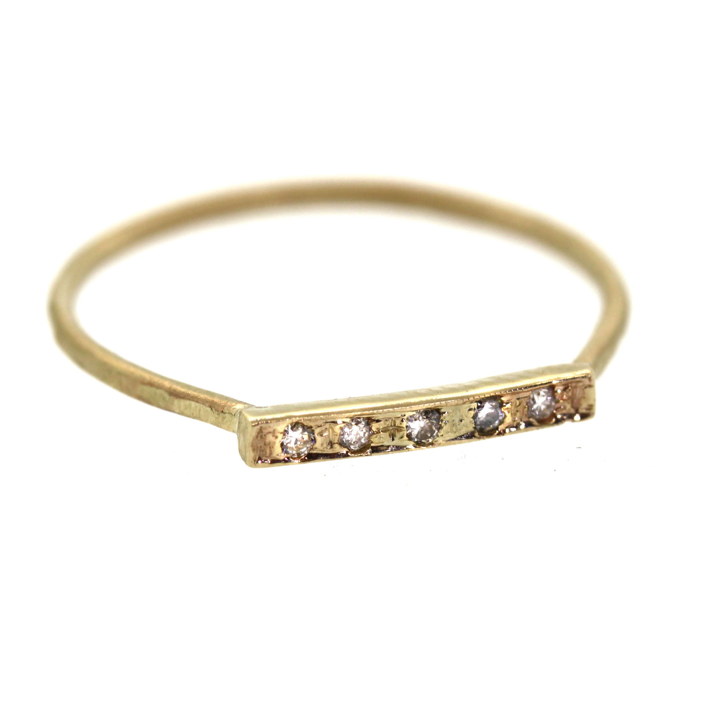 This Diamond Bar Ring features 5 shimmering diamonds pave set into a bar across a yellow gold band. It was handcrafted at Rebecca Lankford Designs in Houston, Texas.