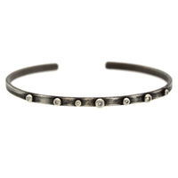 This Silver Studded Diamond Cuff features 7 shimmering diamonds bezel set in sterling silver all soldered on to a brushed rhodium plated silver cuff. It was hand crafted at Rebecca Lankford Designs in Houston, Texas.