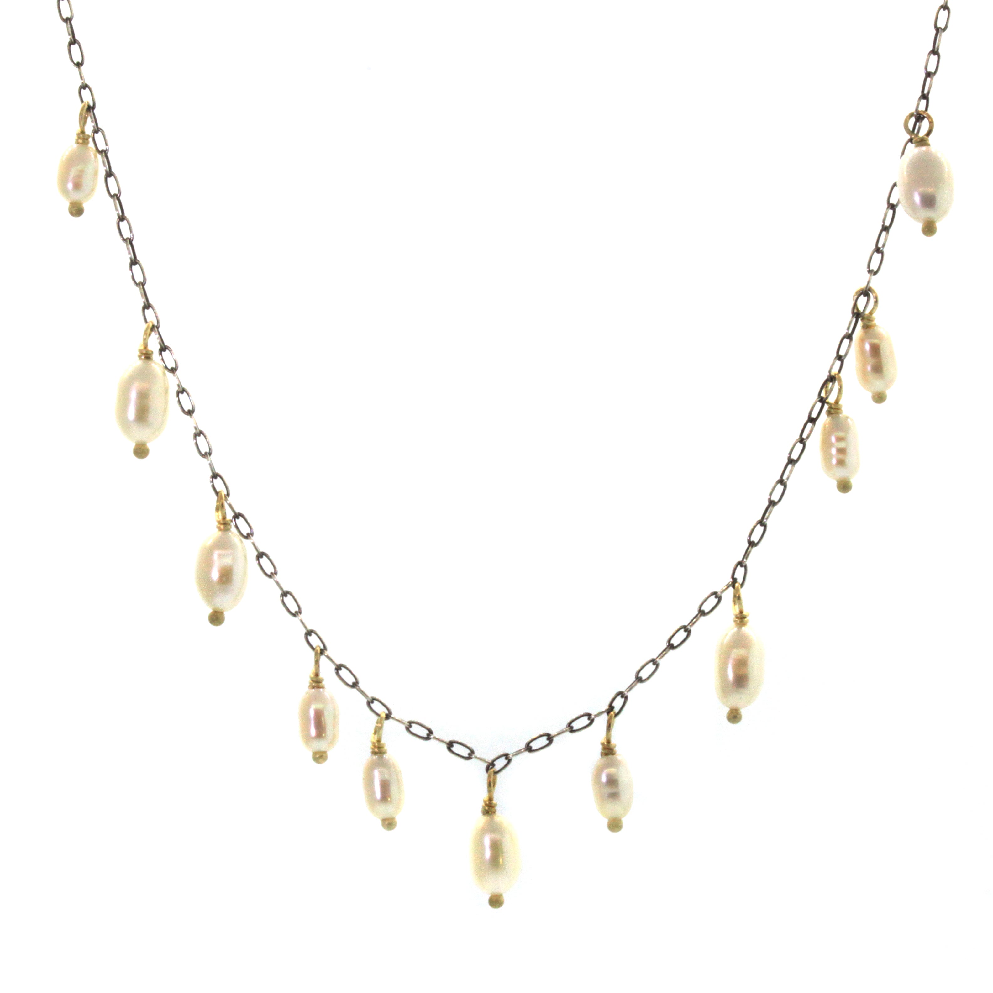 This Cream Biwa Pearl Necklace was hand crafted at Studio 703 + RLD by Rebecca Lankford. It features 11 freshwater cream pearls set in yellow gold and dangling from a brushed oxidized chain. 
