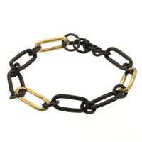 This Chunky Chain Link Bracelet was handcrafted at Rebecca Lankford Designs in Houston, Texas. This bracelet features handmade rhodium plated links with 3 gold links dispersed throughout the bracelet and a toggle closure.