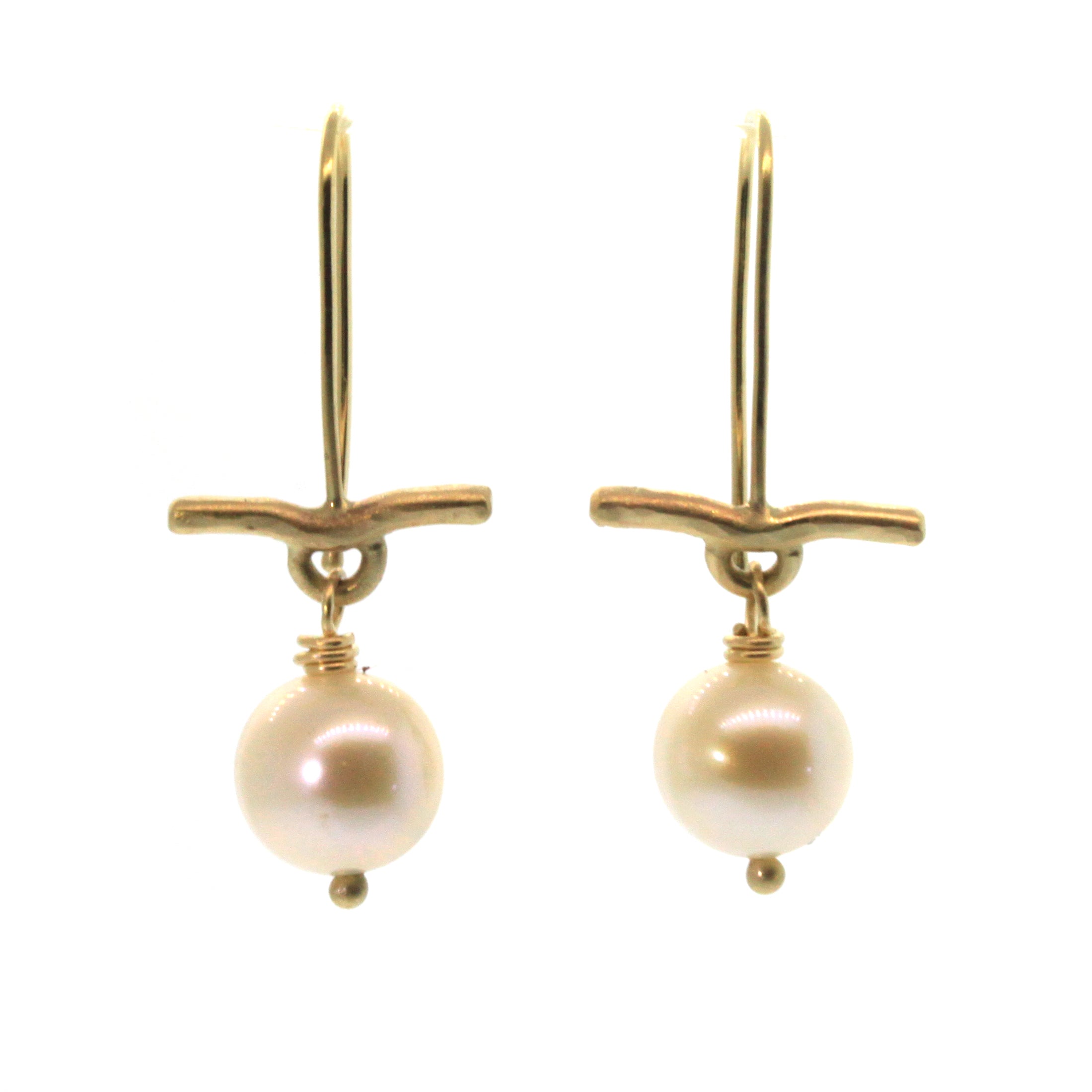 These Pearl & Gold Bar Earrings were handcrafted in Houston, Texas at Rebecca Lankford Designs. This pair features two round cream pearls accented by a textured yellow gold bar dangling from yellow gold ear wire.