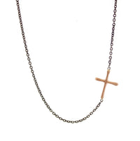 This Sideways Gold Cross is a simple RLD classic. Featuring a gold cross soldered sideways into an oxidized silver chain, this necklace is a subtle reminder of faith and a sweet pop of gold
